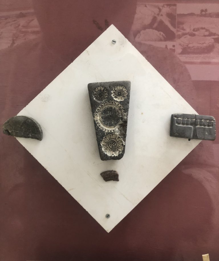 Coin moulds and clay moulds found at the site displayed at the Centenary Heritage Museum, 2023